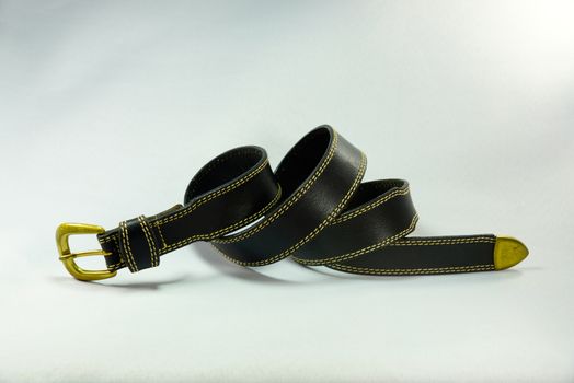 black leather belt on white scene,shallow focus