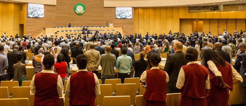 Addis Ababa, Ethiopia - April, 2014: Participants of the of the 20th Anniversary Commemoration of the Rwanda Genocide stand to observe a minute of silence at the AU Nelson Mandela Hall, on 11 April, 2014, in Addis Ababa, Ethiopia