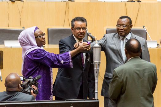 Addis Ababa, Ethiopia - April, 2014: Foreign minister of Ethiopia Dr. Tedros Adhanom, and Ambassador Nsengimana light the relay of a “flame of remembrance" which symbolizes memory, hope and preventing genocide, on 11 April, 2014, in Addis Ababa, Ethiopia