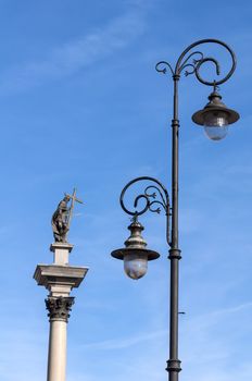Street lamp and statue of Zygmunt III Vasa in Warsaw, Poland.