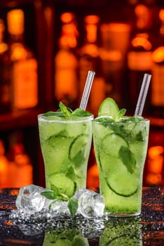 fresh summer coctail in ice by cucumber