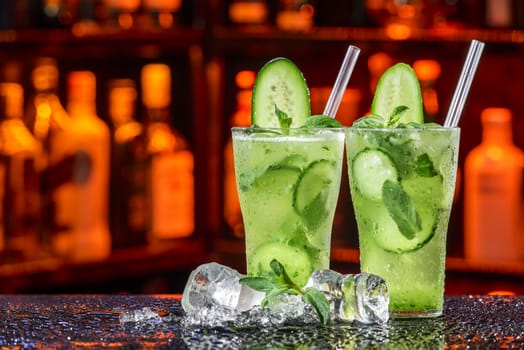 fresh summer coctail in ice by cucumber
