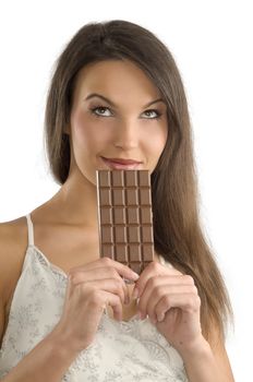 pretty brunette thinking about to eat or not a block of chocolate