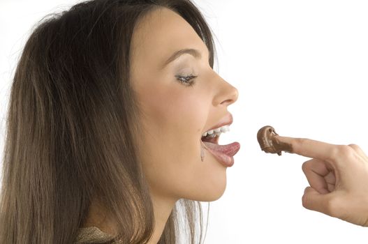 nice closeup of a brunette licking some chocolate cream from her finger