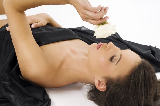 very nice brunette laying down and kissing a white rose