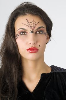 young and nice brunette with spider web painted on face