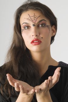 cute young woman with a spider web painted on face