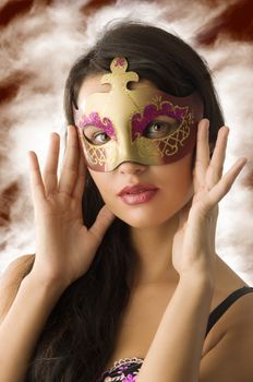 close up of cute brunette with carnival golden mask