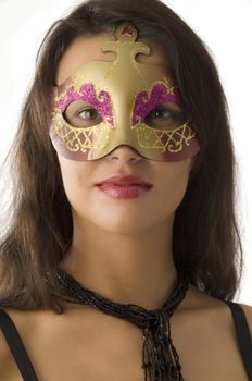 close up of young and cute brunette with carnival mask