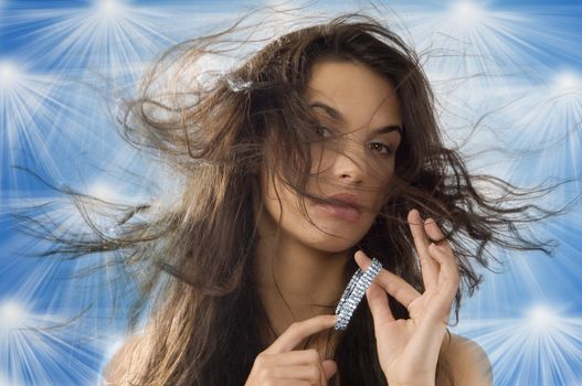 cute brunette playing with silver jewel and windly hair