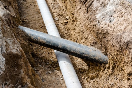 Construction site with pipes crossing each other in a pit