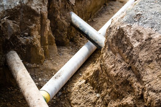 Construction site with pipes crossing each other in a pit