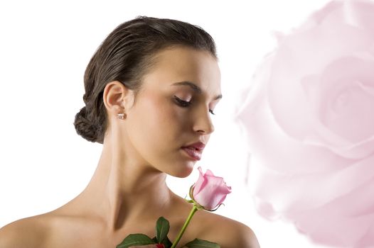 close up portrait of a cute girl brunette looking a pink rose