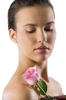 close up portrait of a pretty brunette with a pink rose