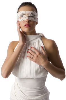 cute brunette in white elegant short with a lace mask looking in camera