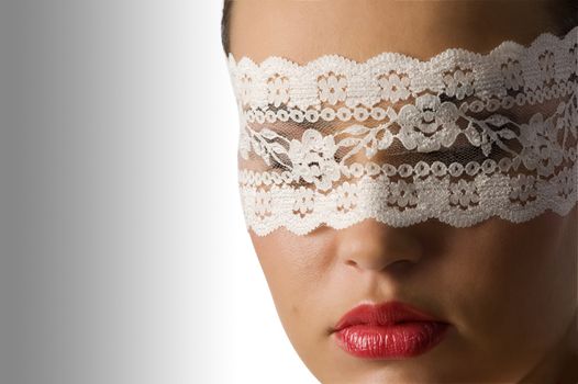 close up on the face of a cute young woman with red lips and white lace mask