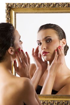 beauty portrait of young woman looking in camera from the mirror