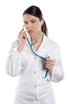 young woman brunette in white medica gown with stethoscope Isolated over white background