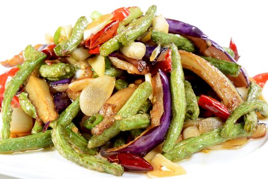 Chinese Food:  Fried eggplant slices with beans in a white plate