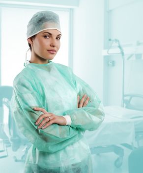 pretty nurse wearing a surgery dress with cap isolated over white looking in camera