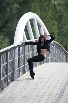 casual sport dressed woman doing fitness exercise outside on a bridge
