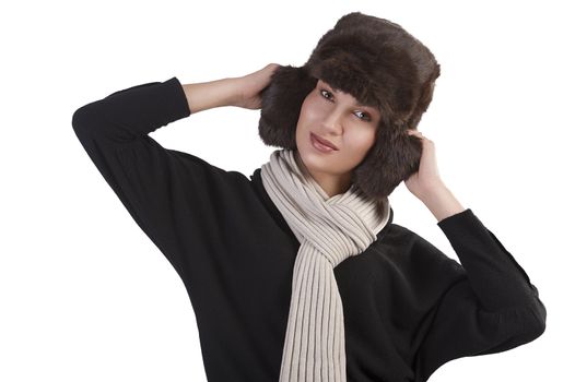 beauty close up portrait of cute female woman with fashion fur hat in winter dress with scarf standing with fun pose against white background