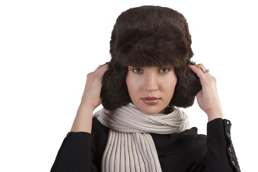 beauty close up portrait of cute female woman with fashion fur hat in winter dress with scarf against white background