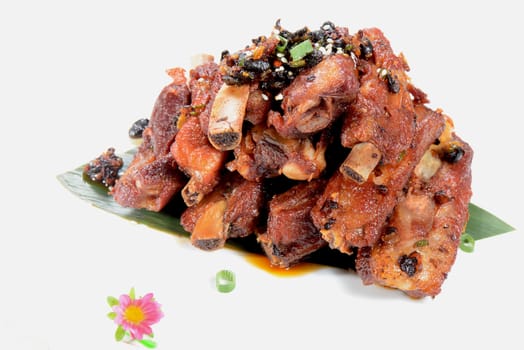 Chinese Food: Fried pork steak with black beans on a white background