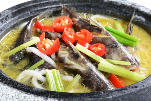 Chinese Food: Boiled small fish with pepper in a stone pot