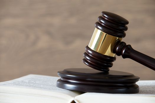 wooden gavel and books on wooden table