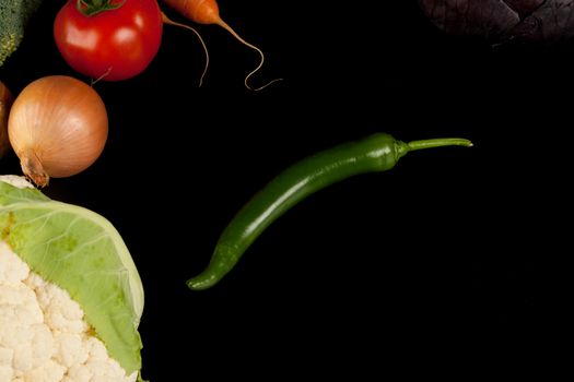 different vegetables shoot from above on black background