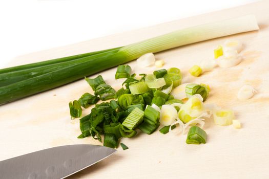 onion on cutting board with different vegetables in the background