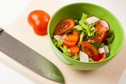 vegetable salad in a green bowl with different vegetables