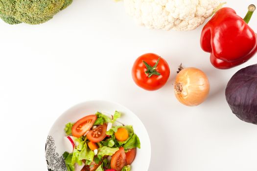 vegetable salad in a white bowl with different vegetables