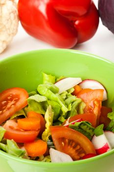 vegetable salad in a green bowl with different vegetables