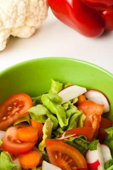 vegetable salad in a green bowl with different vegetables