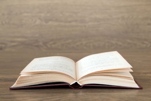 Open book on wood background