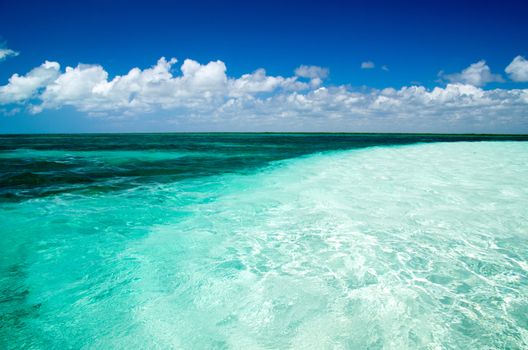 Blue sea under clouds sky