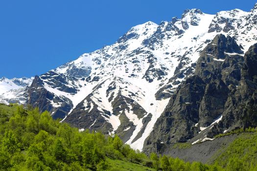 Caucasus mountains under snow and clear blue sky