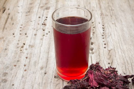 roselle mocktail drink with dry roselle on wood background