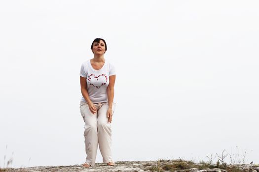 Adult smiling woman ready to jump outdoor