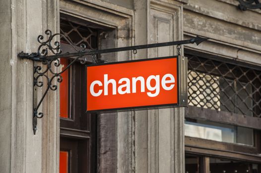 Change sign hanging from a wall