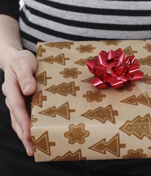 Young woman holding a present in hands