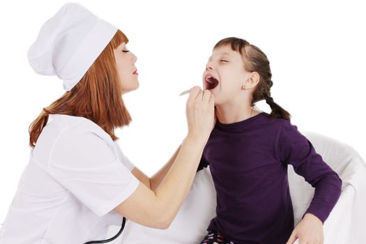 Doctor woman checking the throat of a young patient girl over white