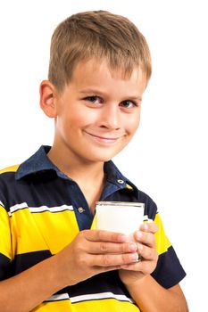 ��ute boy is drinking milk. Schoolboy is holding a cup of milk isolated on a white background