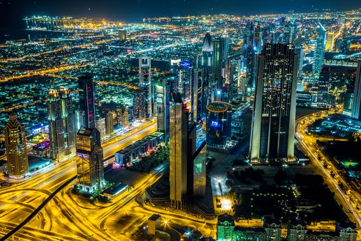 Dubai downtown night scene with city lights, luxury new high tech town in middle East, United Arab Emirates architecture