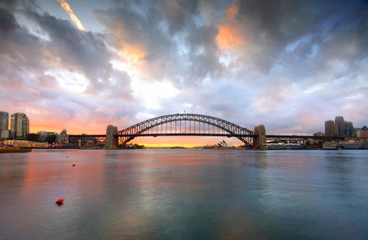 SYDNEY, AUSTRALIA - APRIL 9, 2014; Sydney Harbour Bridge, Sydney Opera House, Luna Park and city CBD at sunrise.  Australia