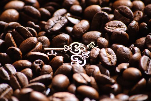 Close-up of roasted coffee beans. And two keys.