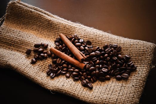 Close-up of roasted coffee beans and pieces of cinnamon