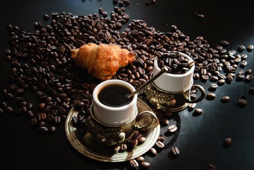 Image of two cups of coffee with croissant.